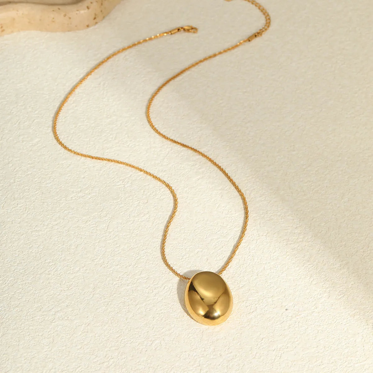 Gold geometric pendant necklace on adjustable chain with stainless steel construction
