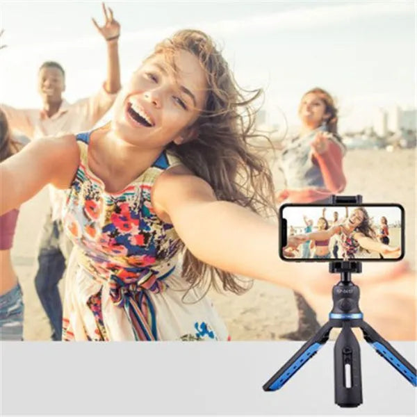 Black desktop phone tripod stand compatible with iPhone models on a desk