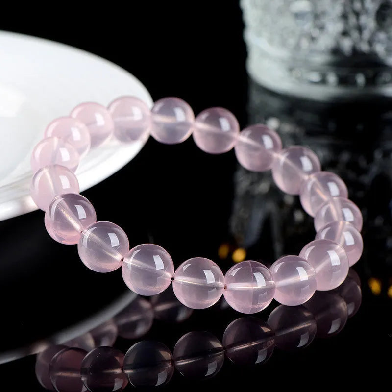 Natural starlight crystal round bead bracelet in pink with polished finish showing bead detail