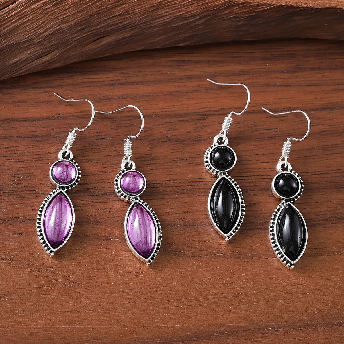 Pair of black and purple geometric vintage pendant earrings with round decorative elements