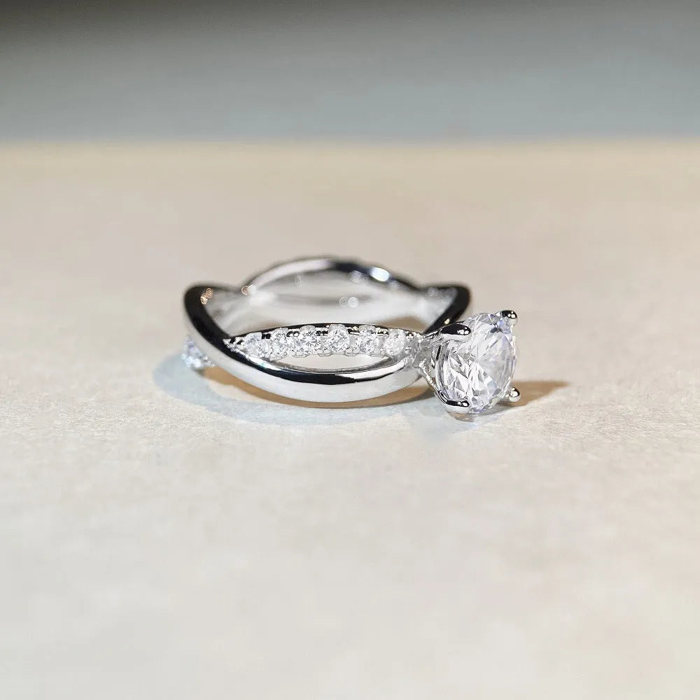 Silver moissanite ring with 1 karat stone and cross twisted arm geometric design