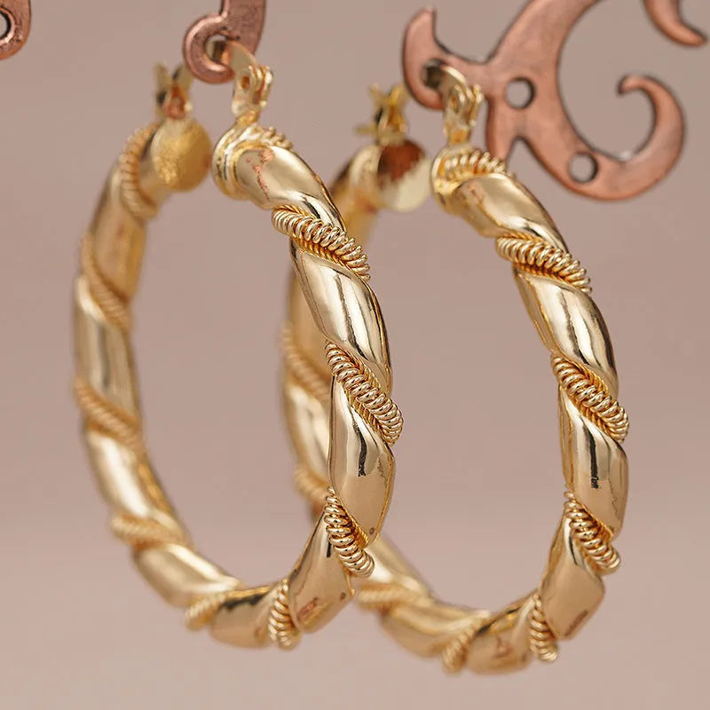 Geometric copper earrings for women with ring and line details in golden colour.