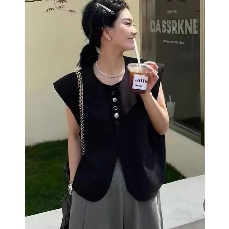 Women's loose fit polyester vest in milky white colour with pockets.