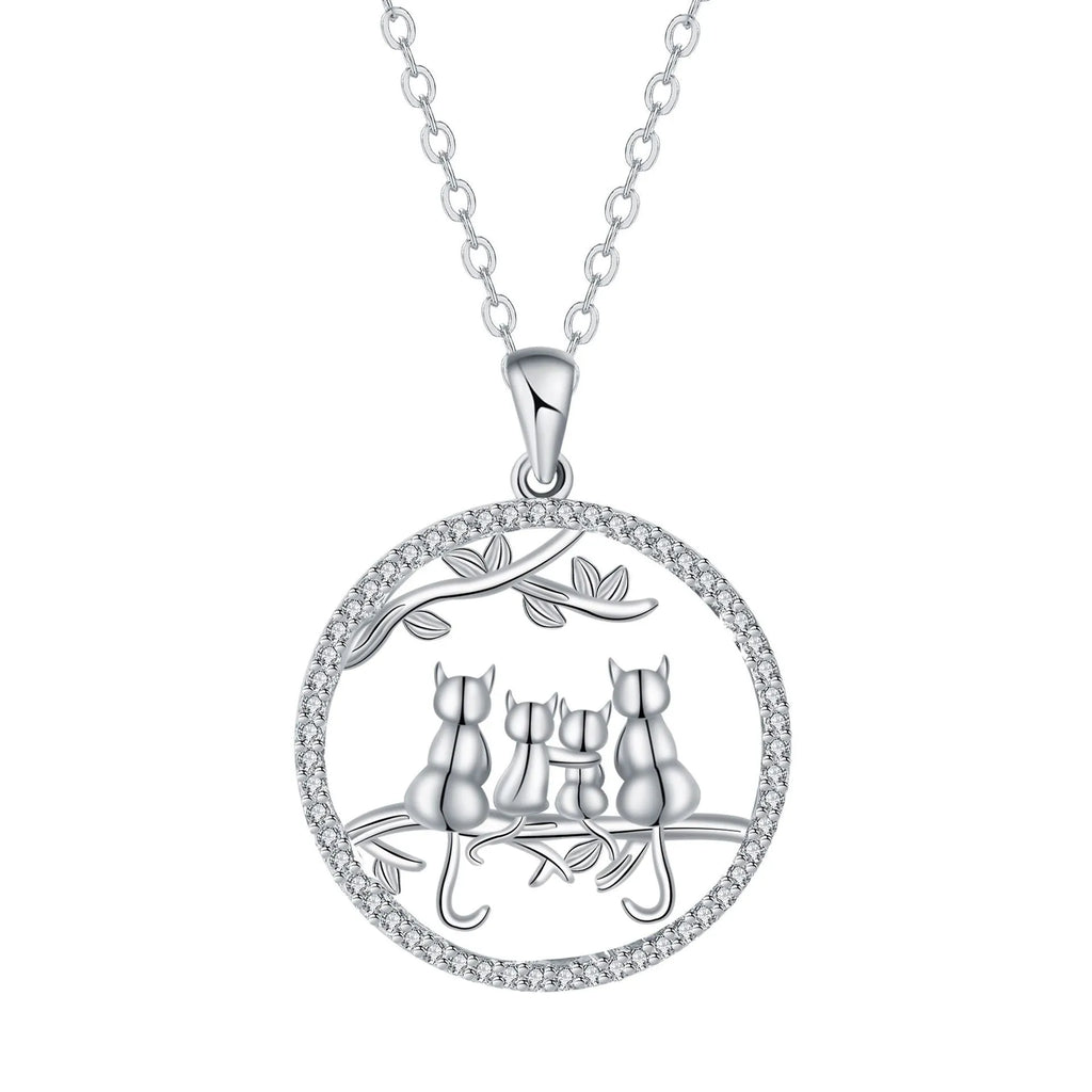 Close-up of a copper necklace featuring a pendant with four kittens in an original design, on a cross chain.