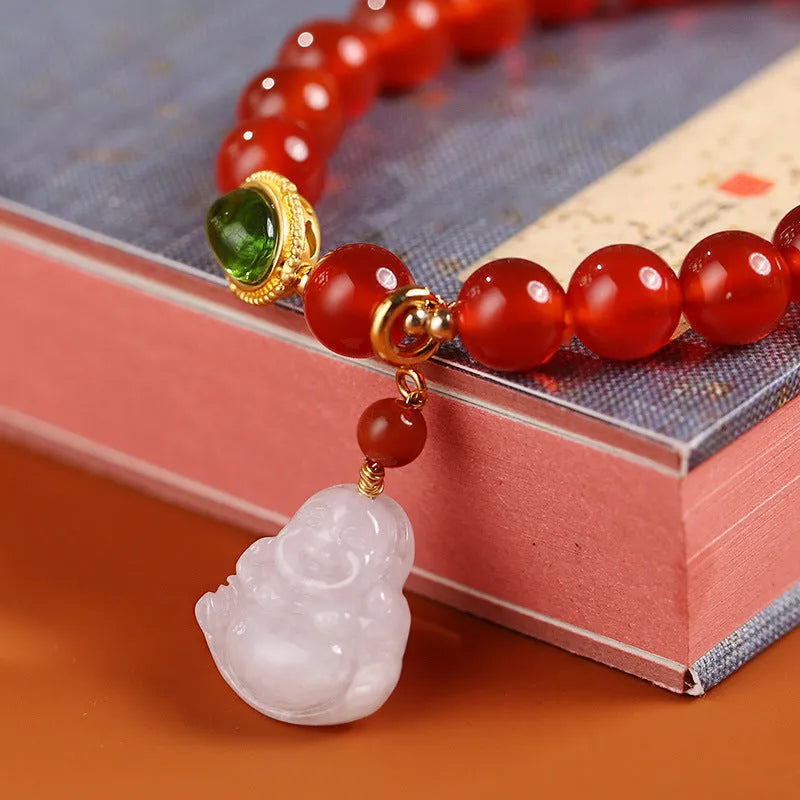 Chinese style women's bracelet with red agate, amber beads and gold Maitreya Buddha pendant on wrist