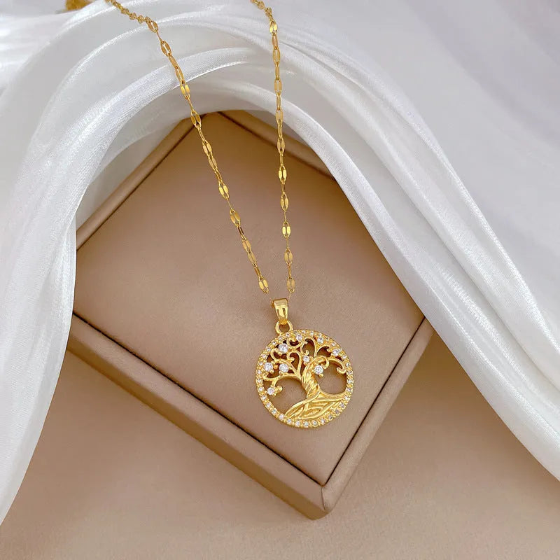 Gold-plated necklace with rhinestone lucky tree pendant featuring mother-of-pearl shell accents on stainless steel chain