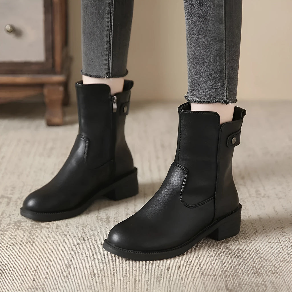 Black women's ankle boots with side zip, round toe, and low rubber sole