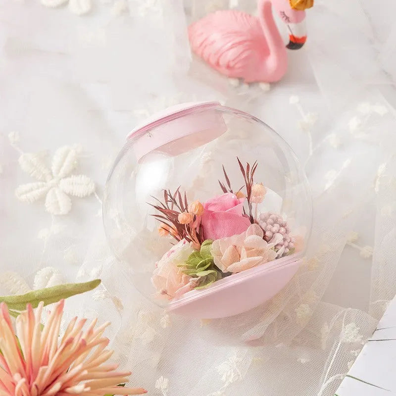 Pink preserved rose in ABS PC PVC ornament with Bluetooth base on tabletop
