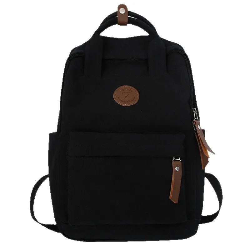Black Oxford cloth leisure backpack with curved shoulder straps showing retro sewing thread details