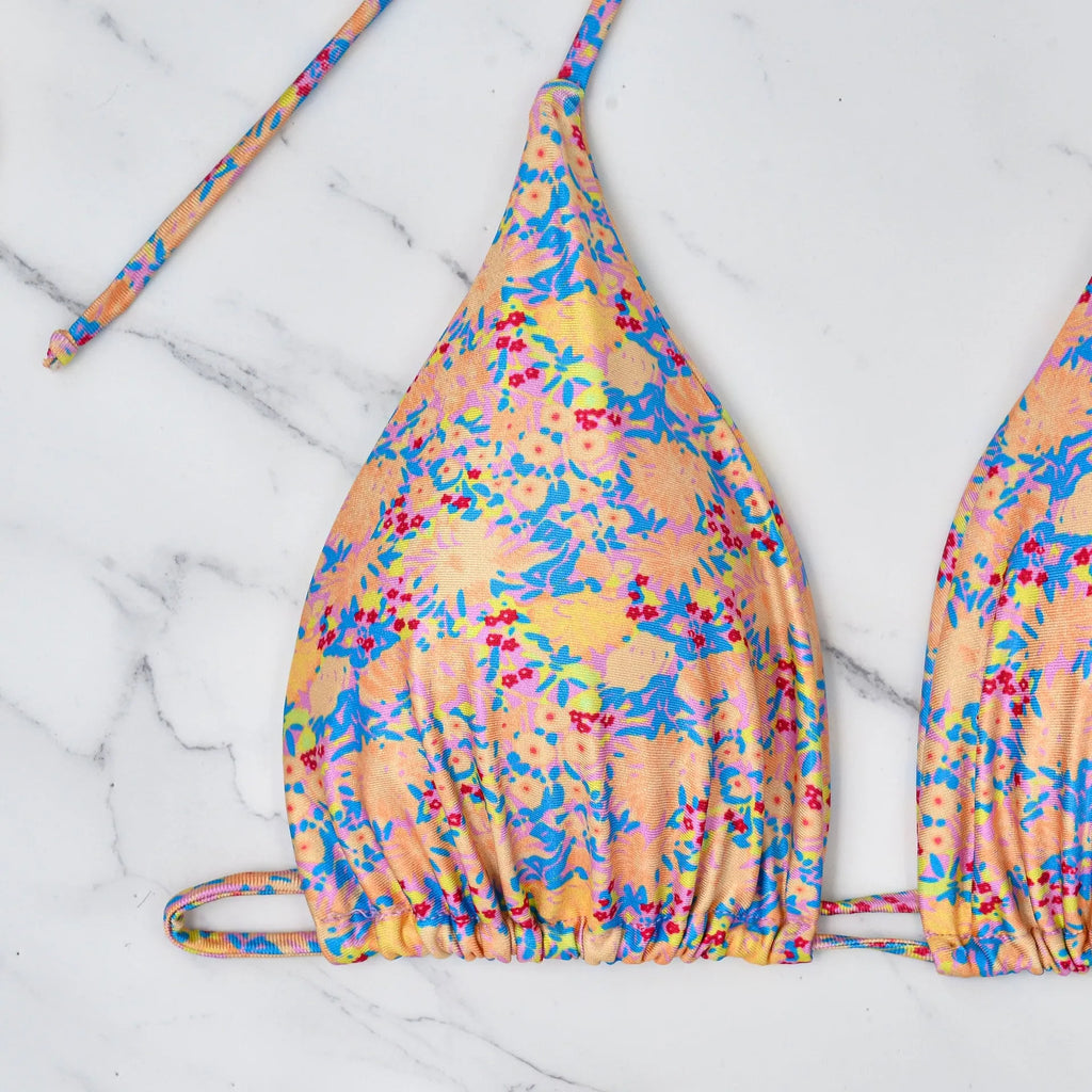 A pictured colour lace-up bikini swimsuit with adjustable ties and a backless briefs design.