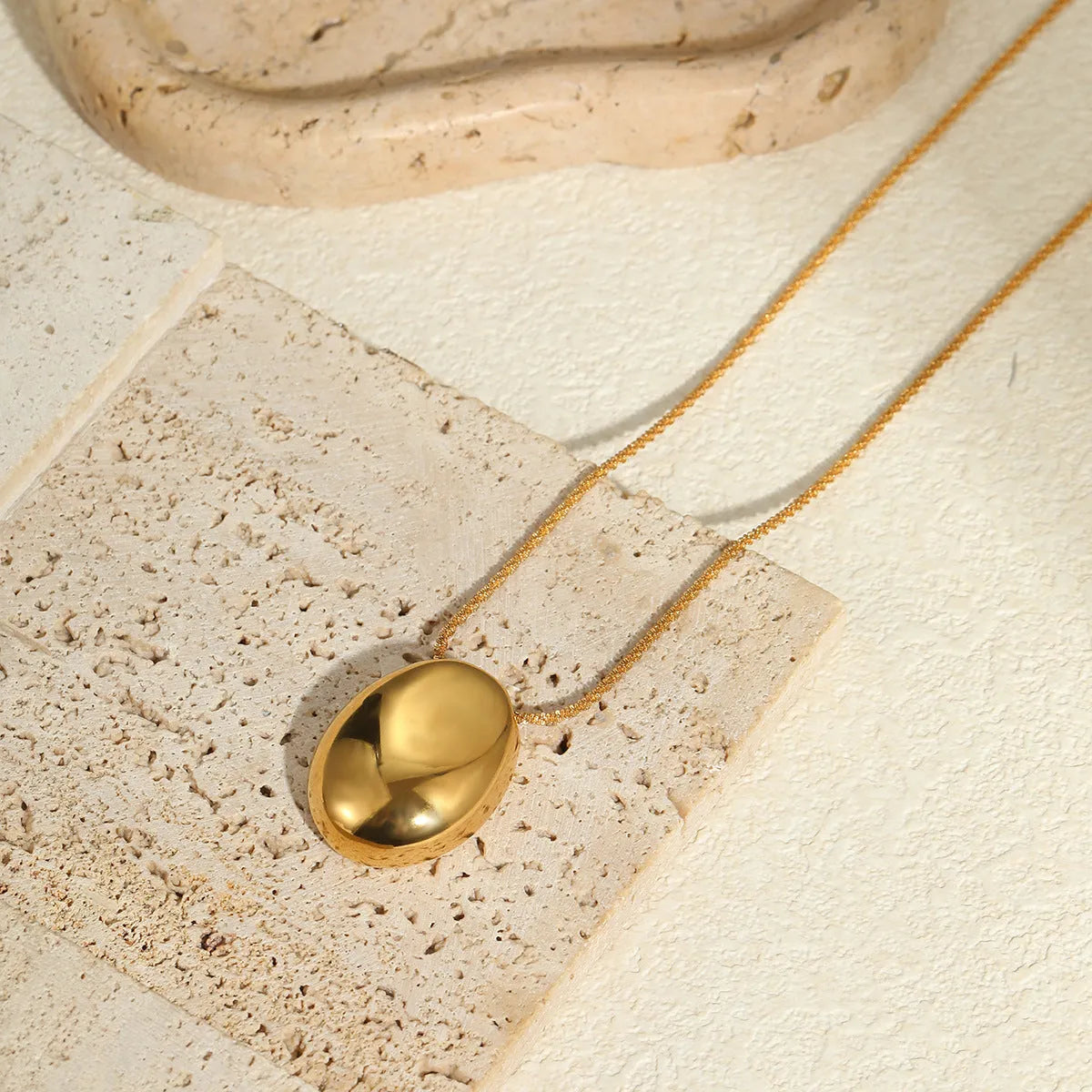 Gold geometric pendant necklace on adjustable chain with stainless steel construction