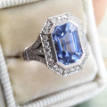 Blue long hexagon copper electroplated women's ring on plain background, sizes 6 to 10