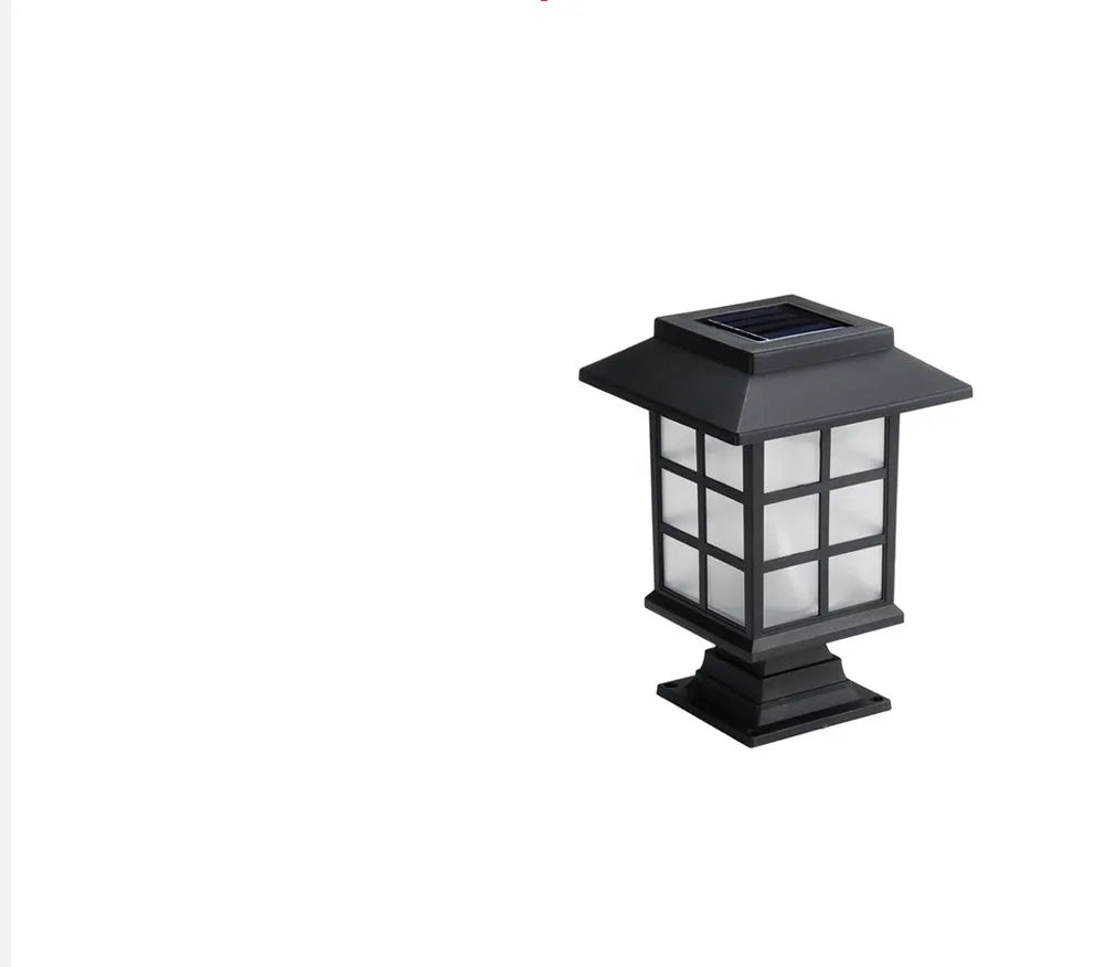 Black solar outdoor LED lawn light with decorative windows, IP65 waterproof, placed in a garden