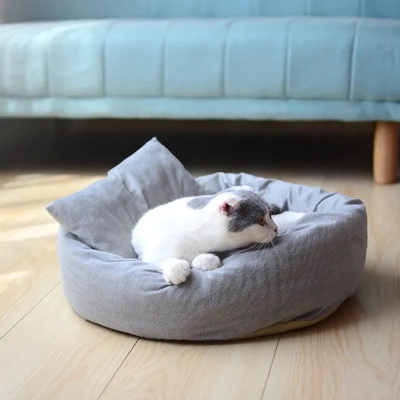 Round grey dog bed with fluffy rim and matching pillow on a non-slip Oxford cloth base.