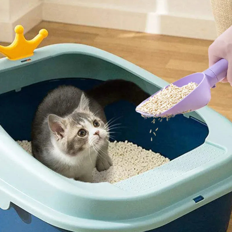 Plastic cat litter scoop with base in white model, showing hidden bag storage compartment and large scoop head with alternating apertures