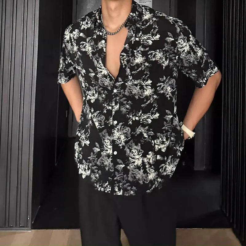 Loose fit black floral print short sleeve casual shirt on a hanger