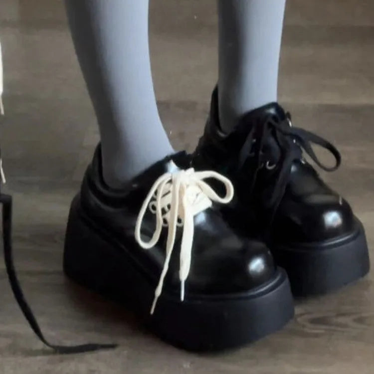 Matte black women's low-top shoes with a chunky 6-8cm heel and thick rubber sole on a white background.
