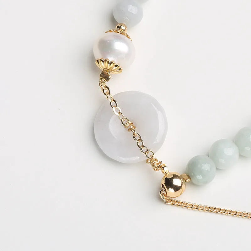 Women's jade bracelet with emerald peace buckle and pearl details in geometric national style design