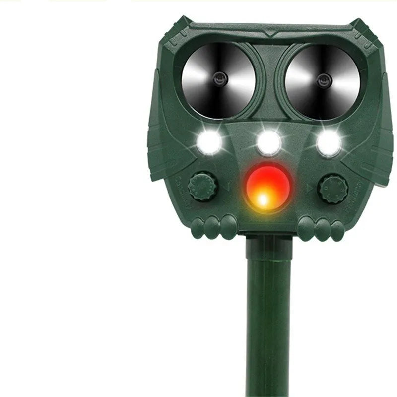 Green solar-powered ultrasonic animal repeller with LED strobe lights for outdoor pest control.