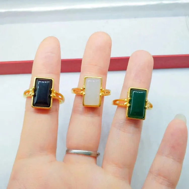 Adjustable brass gold-plated ring with electroplated gemstone inlay showing black, green and white colour options