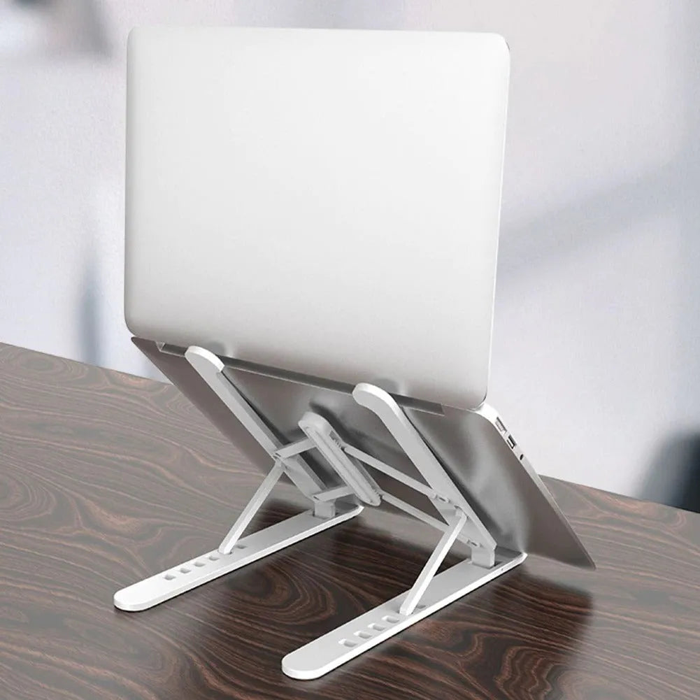 Adjustable non-slip laptop cooling stand in black with six height gears, folded flat on a desk