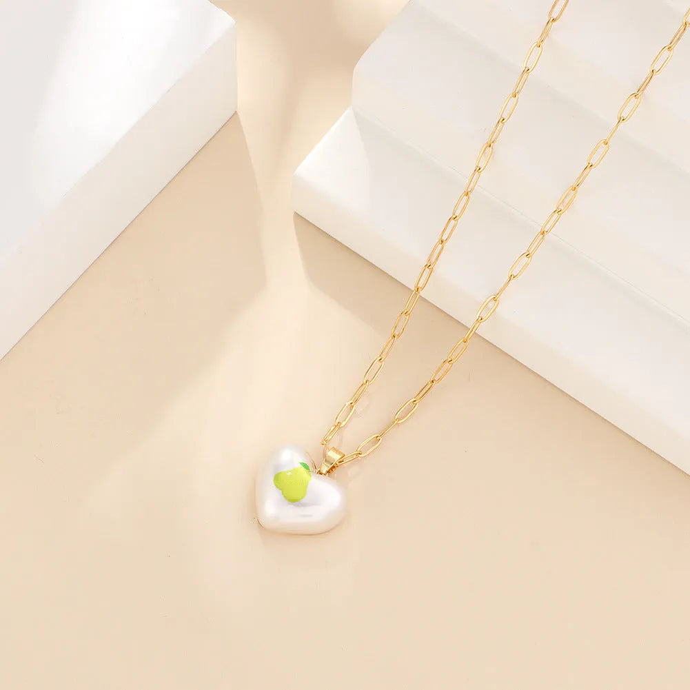 Heart-shaped fruit pendant necklace with strawberry design on adjustable metal chain