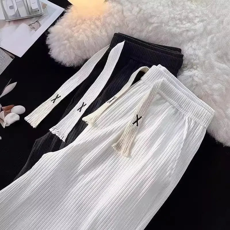 Men's loose straight cotton casual trousers in white, front view, on a model