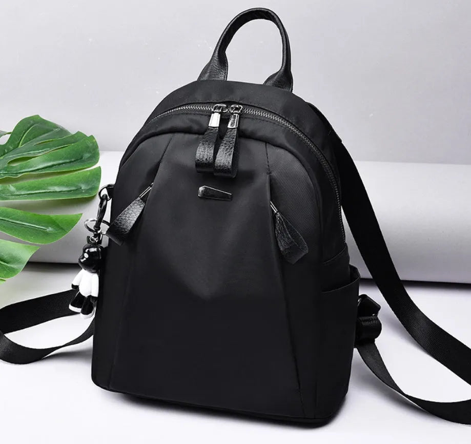 Medium size wine red Oxford cloth rucksack showing internal mobile phone and ID organisation pockets