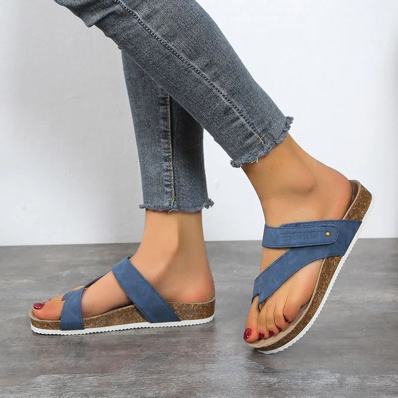 Flat toe ring flip-flops with thick foam sole in blue, shown from the side.