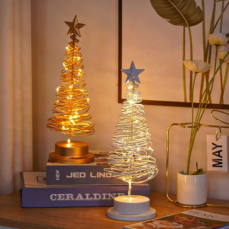 LED Christmas tree spiral light ornament with warm white glow on a table, gold finish