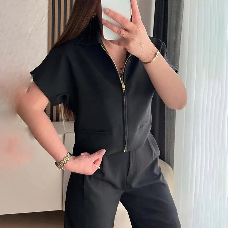 Loose fit casual polyester top in black colour with short sleeves on hanger