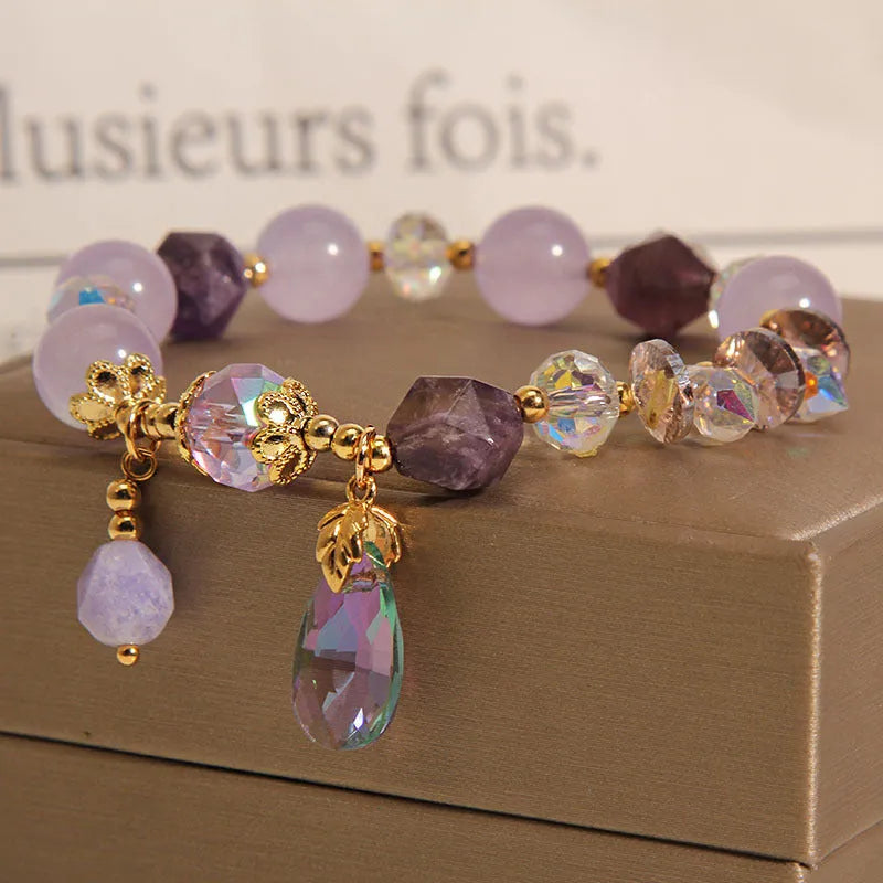 Children's crystal bracelet with lavender purple water-drop crystals on a plain background
