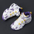 Children's black and coloured rotating button running shoes with a cushion basketball design on a white background
