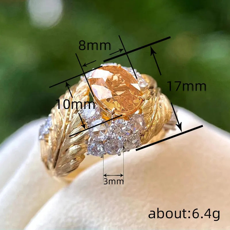 Gold copper feather ring with embossed design and yellow zircon stone in geometric setting