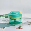 Green manual baby food grinder with 300ml capacity and stainless steel blade