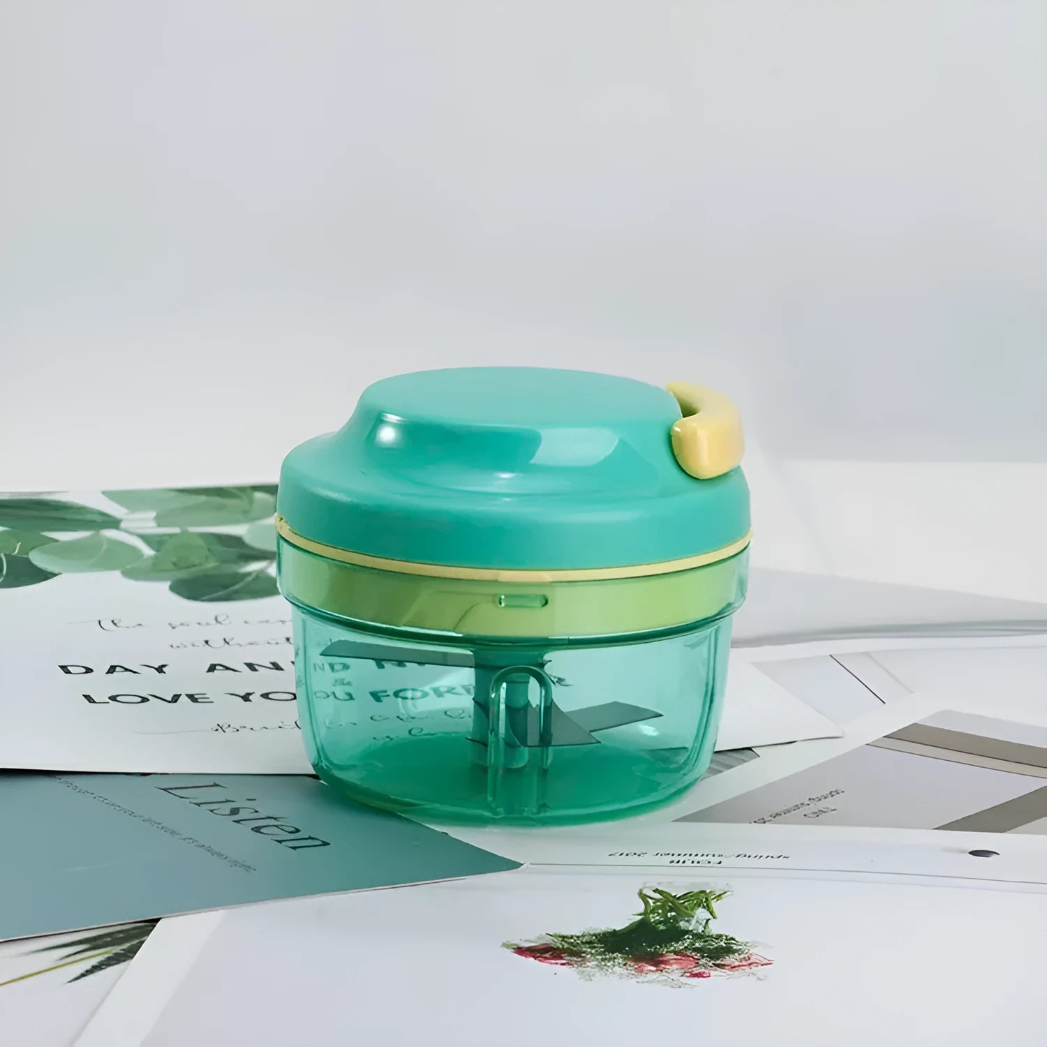 Green manual baby food grinder with 300ml capacity and stainless steel blade