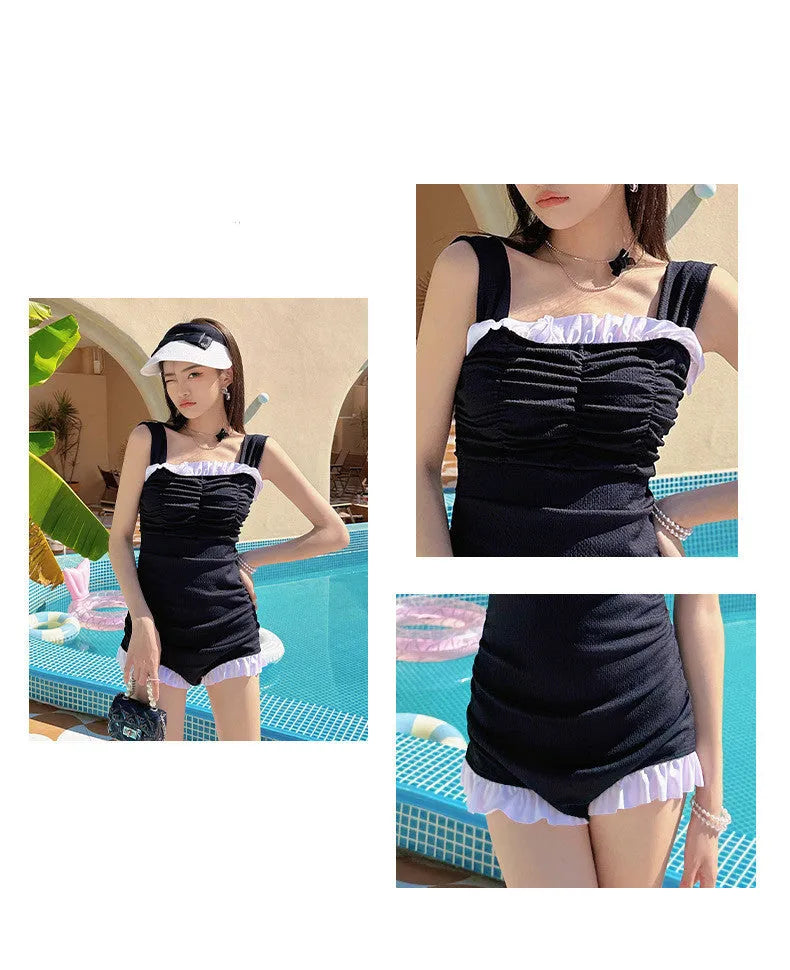Women's solid colour one-piece suspender swimsuit in black, front view, polyester fibre, sizes S to XL