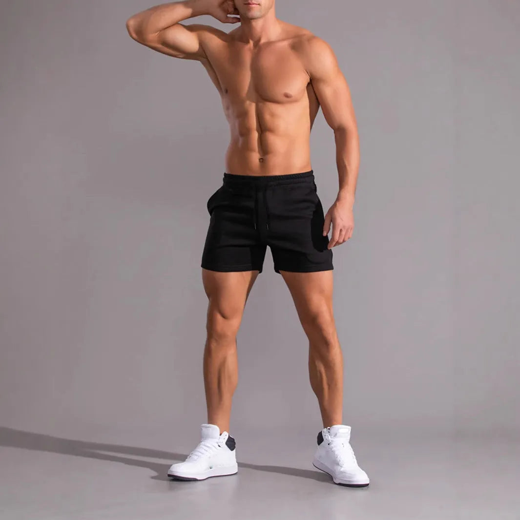 Pack of three men's casual drawstring shorts in black, khaki, and light brown colours laid flat.