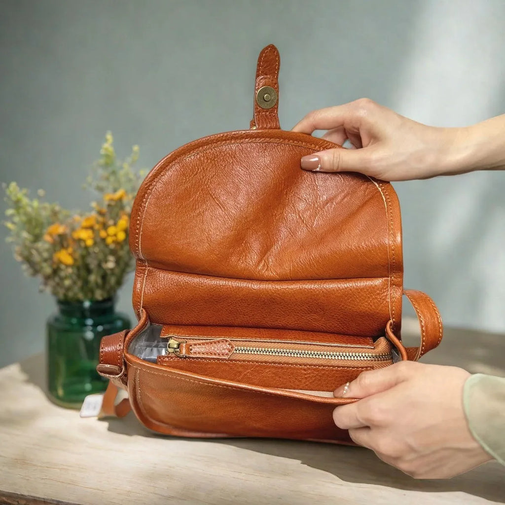 Genuine leather messenger bag with shell shape and sewing line detail in brown