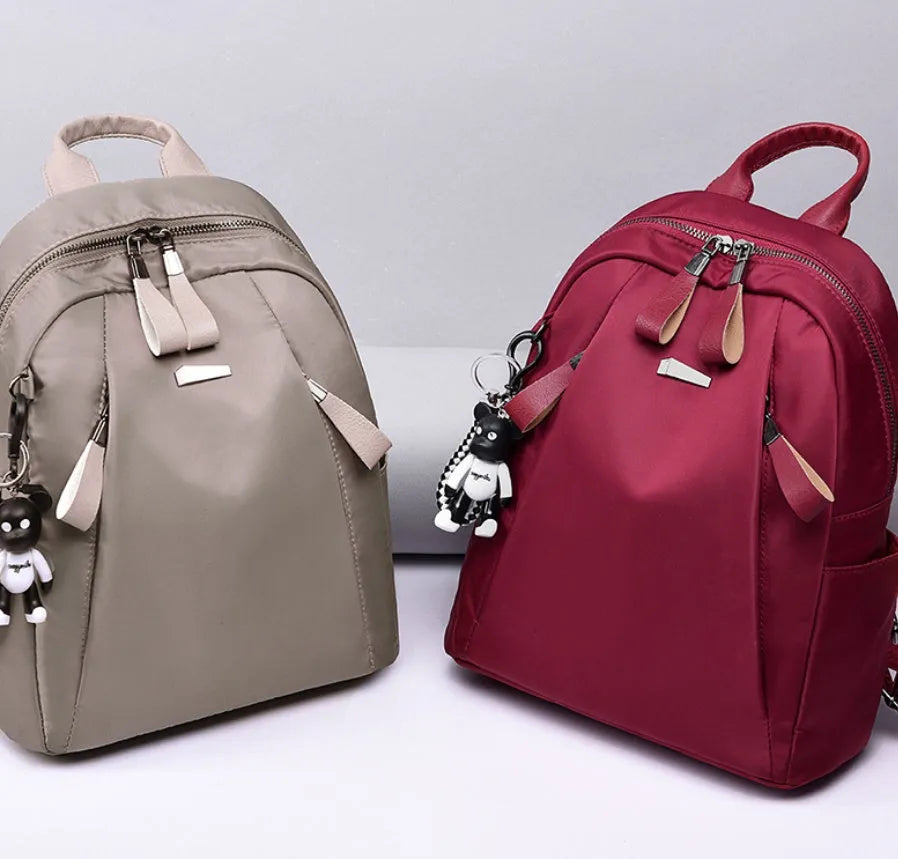 Medium size wine red Oxford cloth rucksack showing internal mobile phone and ID organisation pockets