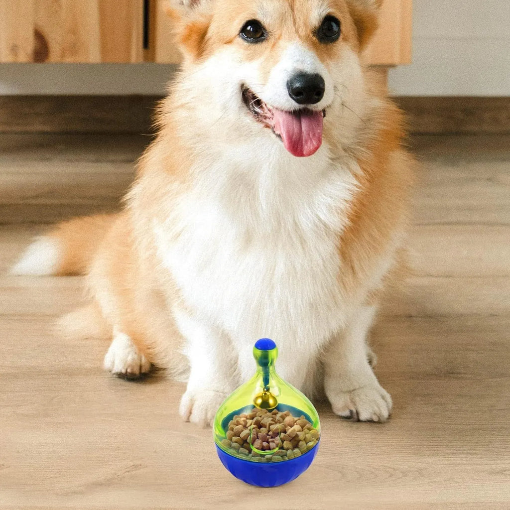 Blue tumbler-shaped interactive treat dispenser ball for dogs and cats on a wooden floor