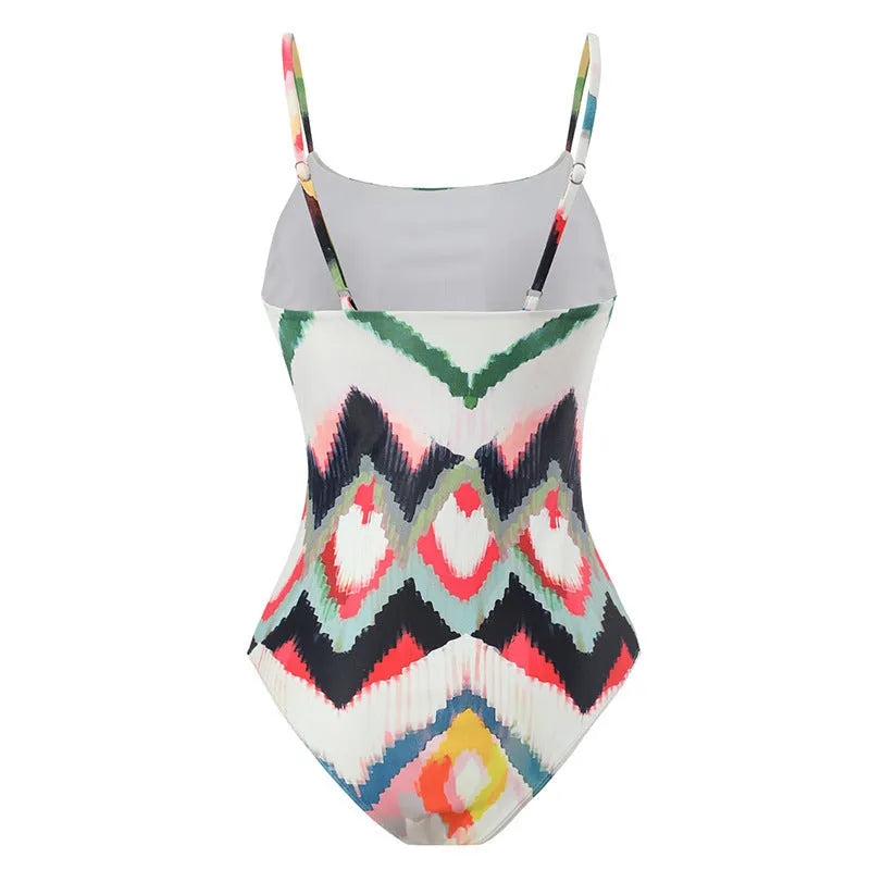 Women's printed two-piece swimsuit with matching hip skirt in striped gradient pattern.