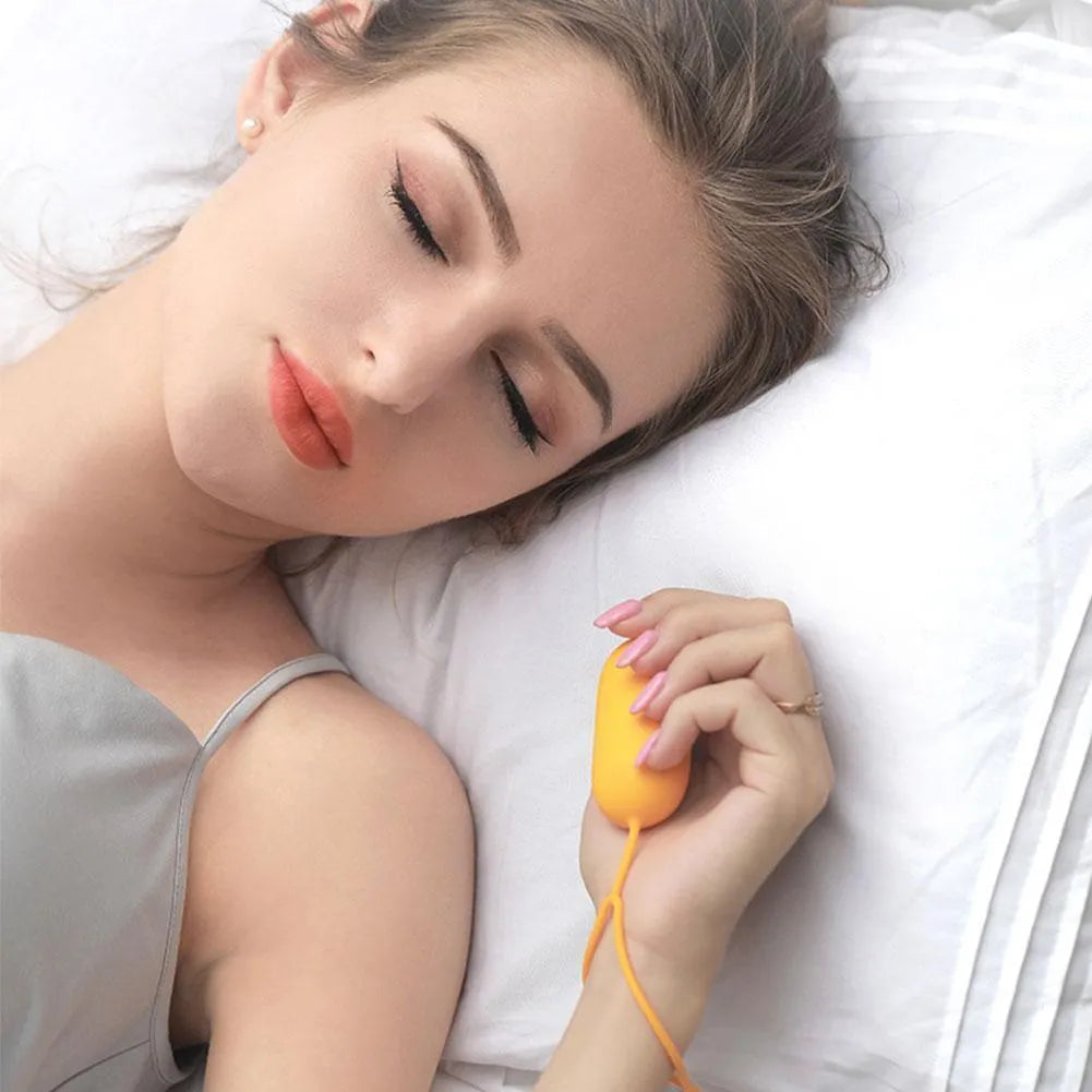 Hand-held micro-current sleep aid device with round button and stainless steel electrodes in grey colour