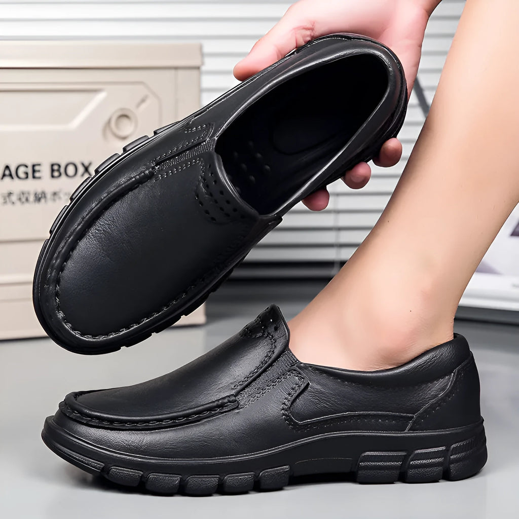Men's slip-on work shoes in black with waterproof platform sole and mid heel, side view