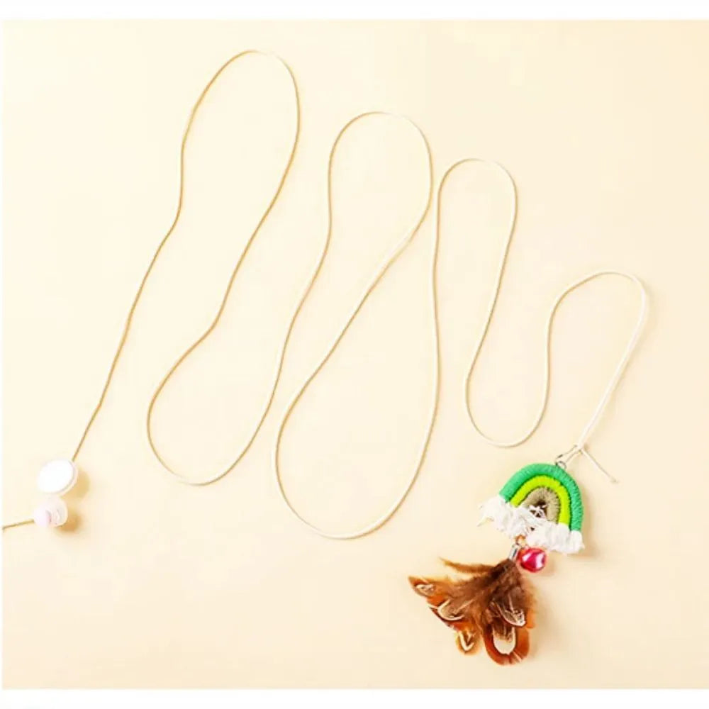 Blue feather rope cat toy hanging from door on elastic cord with adhesive clamp