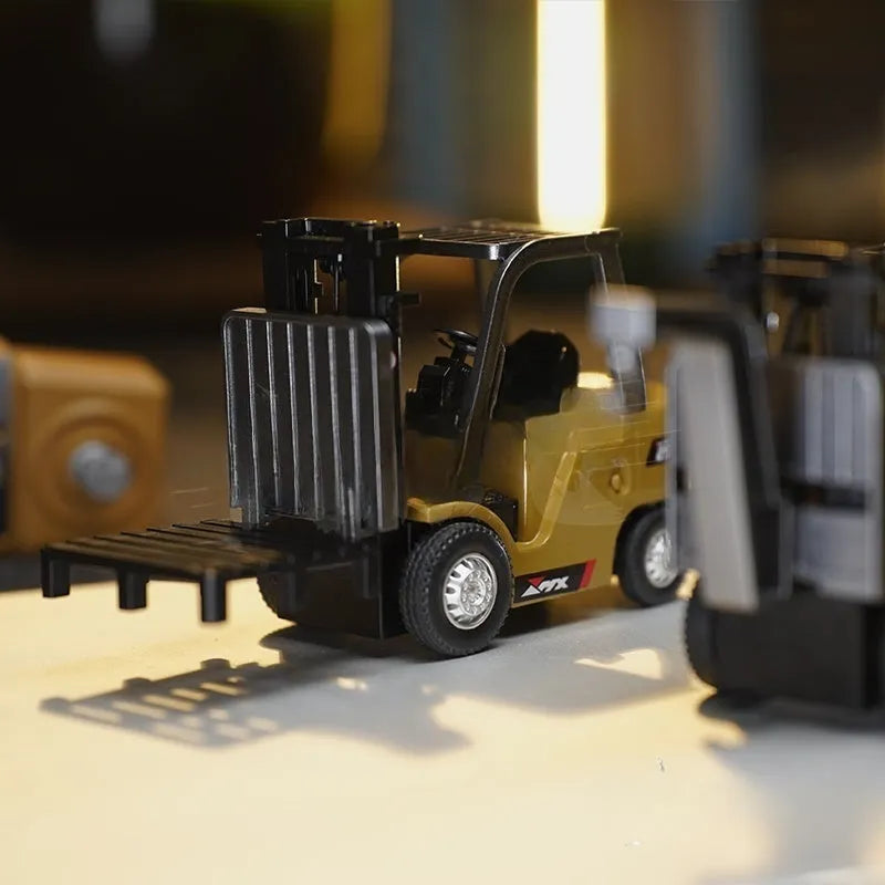 Alloy remote control engineering vehicle set with dump truck, excavator, and small forklift on a table