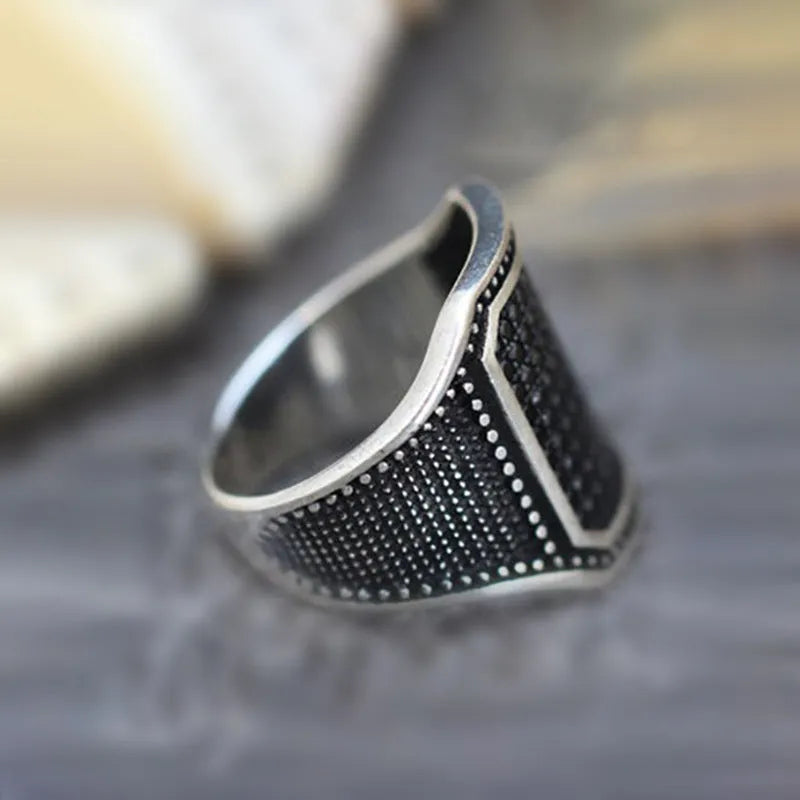 Black alloy ring with copper inlay and zircon detailing shown in unisex design