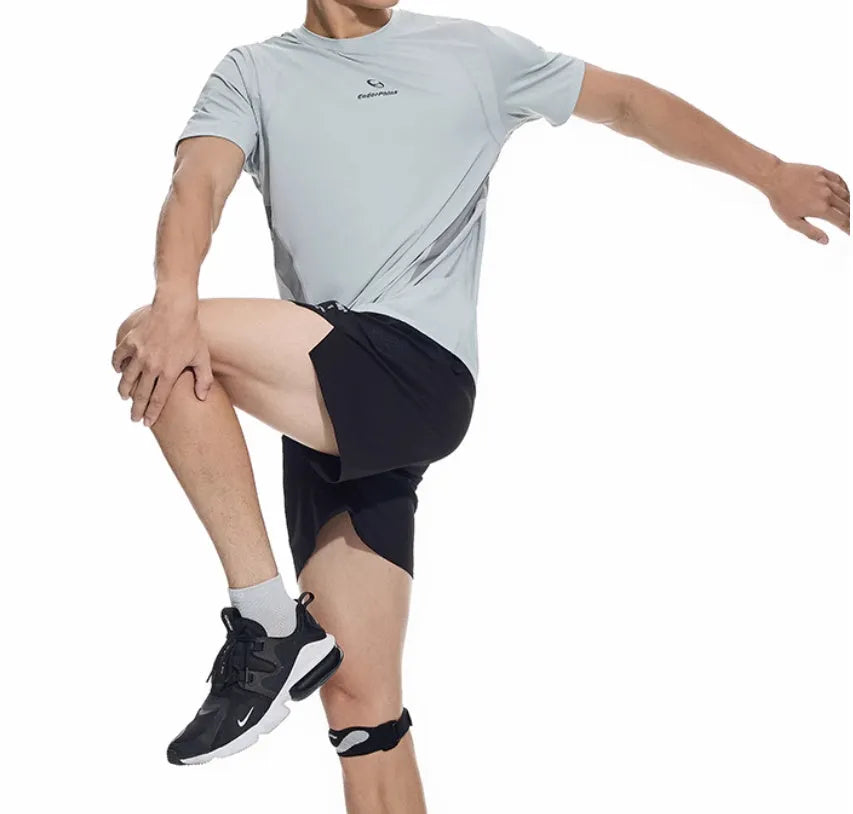 Black running shorts with laser stitching detail on a grey background.
