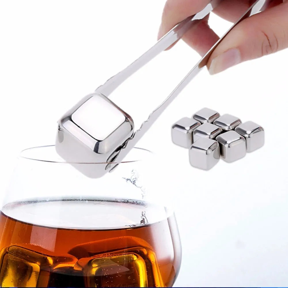 Set of 8 stainless steel ice cubes in square and ball shapes with plastic storage box and tong on a wooden surface