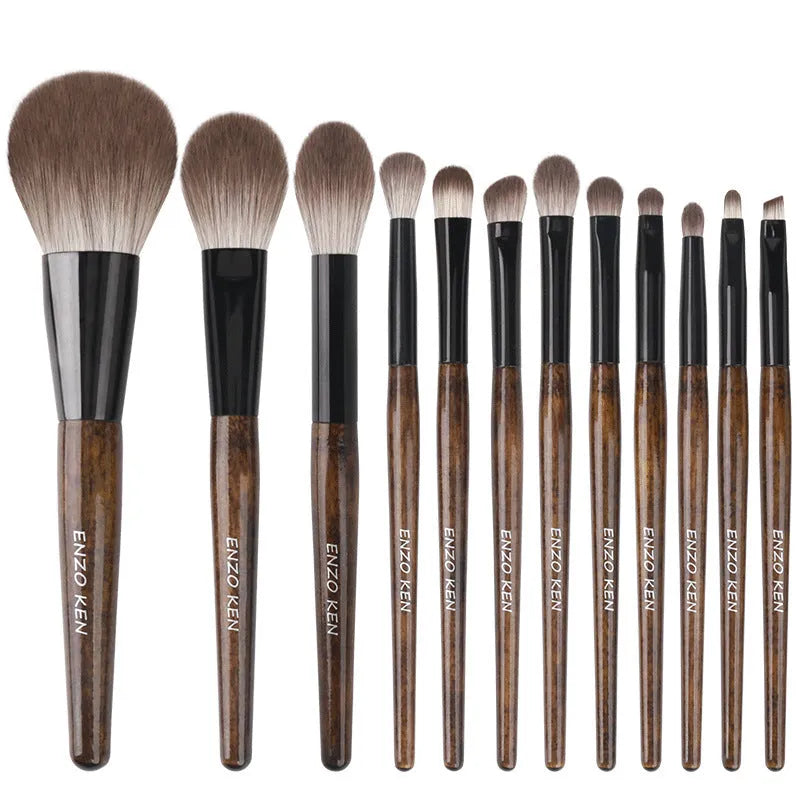 12-piece makeup brush set with wooden handles stored in a black PU zip bag